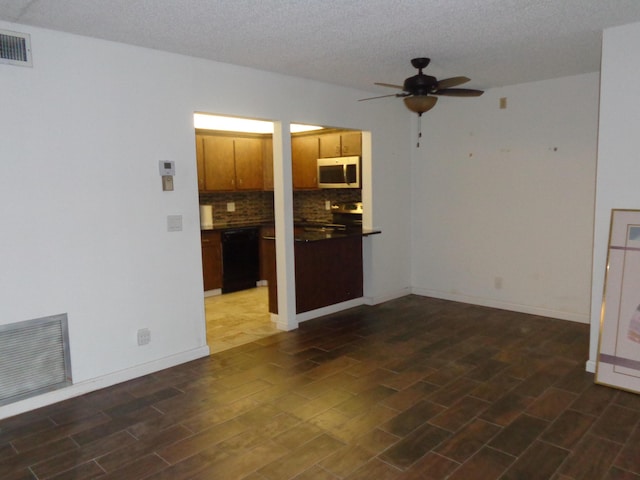 unfurnished living room featuring visible vents, baseboards, a ceiling fan, and wood finished floors