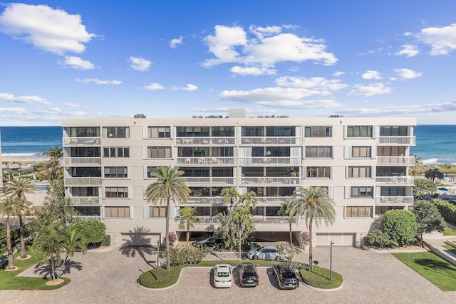 view of building exterior featuring a water view and driveway