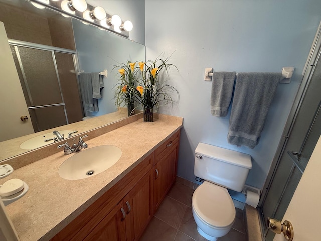 full bathroom with tile patterned floors, toilet, a stall shower, and vanity