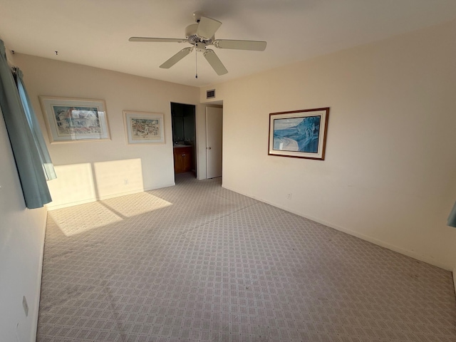 unfurnished bedroom with carpet flooring, ceiling fan, baseboards, and visible vents