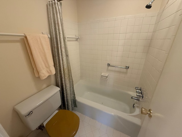 bathroom featuring shower / bath combo with shower curtain, toilet, and tile patterned flooring