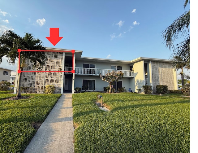 view of front of home with stucco siding and a front lawn