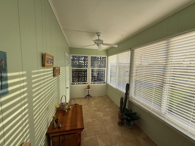 sunroom / solarium with lofted ceiling and a ceiling fan