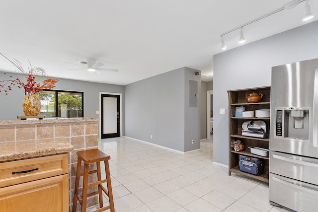 kitchen with a ceiling fan, baseboards, light tile patterned flooring, stainless steel fridge with ice dispenser, and track lighting