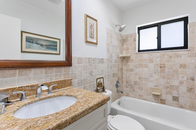 full bath with vanity, toilet, tile walls, and  shower combination