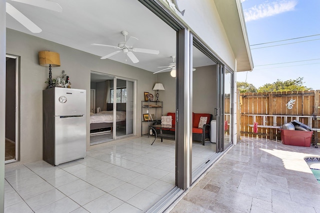 view of patio / terrace featuring ceiling fan and fence