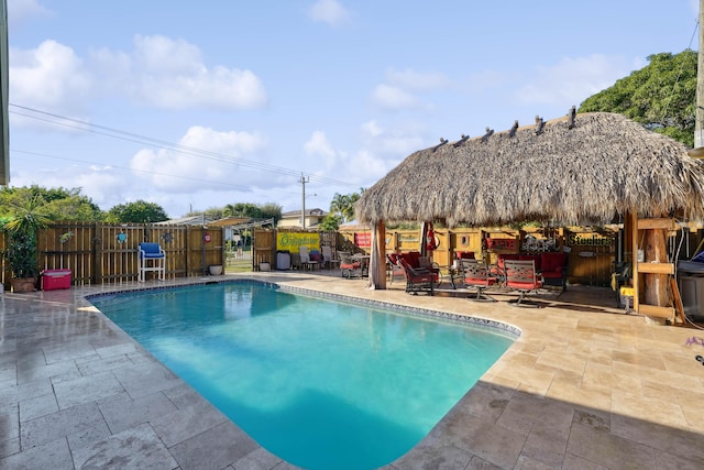 view of pool with a patio area, a fenced in pool, a gazebo, and fence