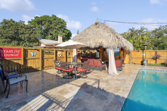 view of pool with a fenced in pool, a fenced backyard, and a patio area