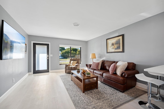 living room featuring light wood-style flooring and baseboards