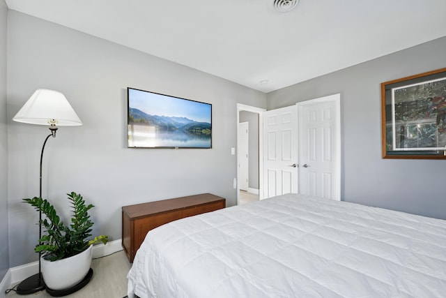 bedroom featuring baseboards and visible vents