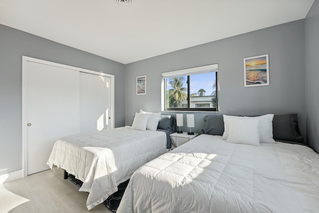 bedroom with a closet and wood finished floors