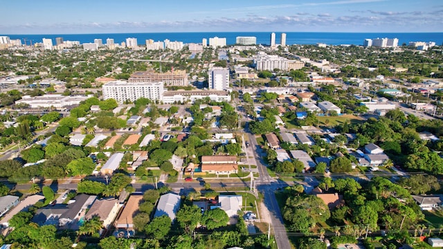 drone / aerial view featuring a view of city and a water view