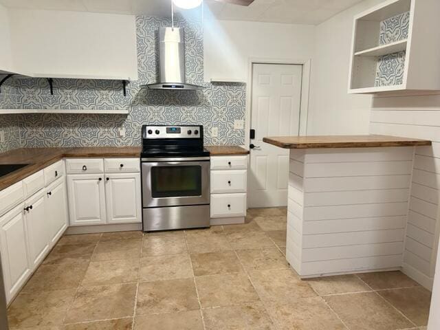 kitchen featuring stainless steel range with electric stovetop, open shelves, wood counters, backsplash, and wall chimney range hood