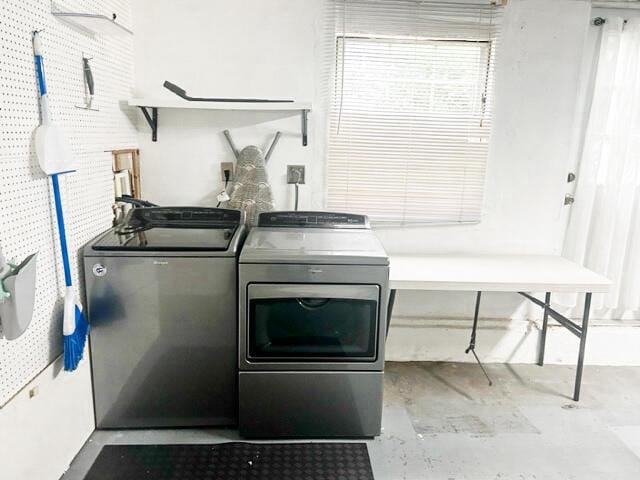 clothes washing area with laundry area, independent washer and dryer, and a sink