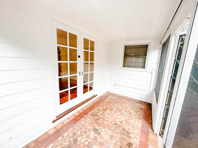 unfurnished sunroom featuring french doors