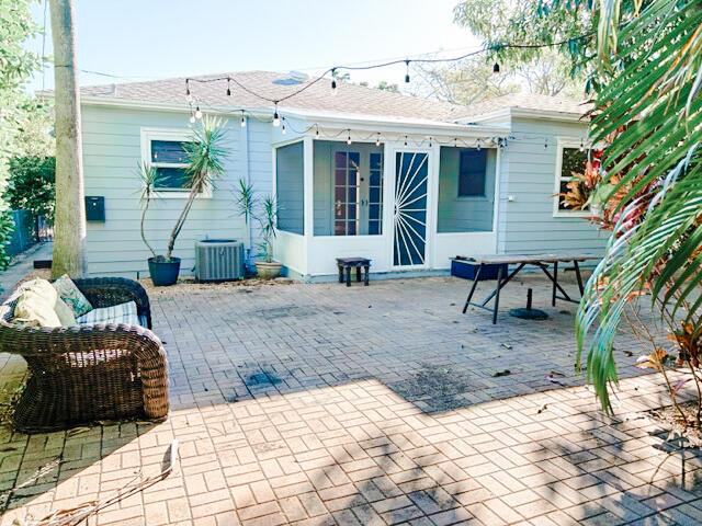 back of house with cooling unit and a patio