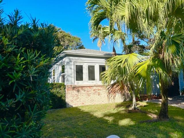 view of side of home featuring a yard