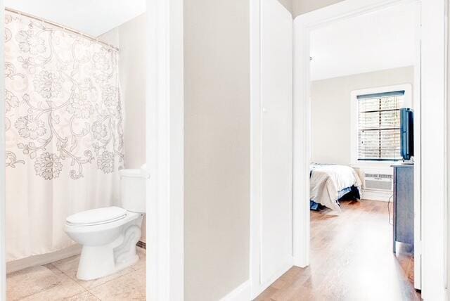 bathroom featuring curtained shower and toilet