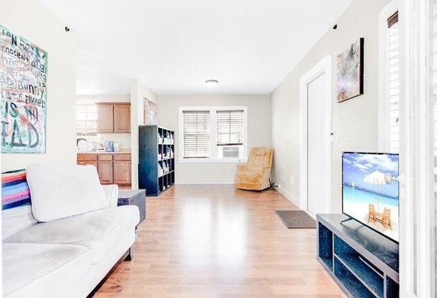 living room featuring light wood-style flooring and baseboards