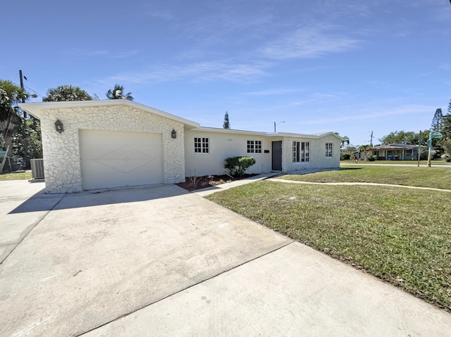 ranch-style home with driveway, an attached garage, and a front yard