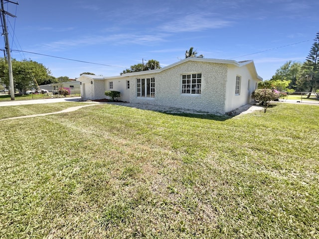 exterior space featuring stucco siding and a yard