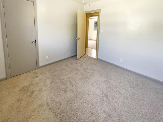 unfurnished bedroom with carpet and baseboards