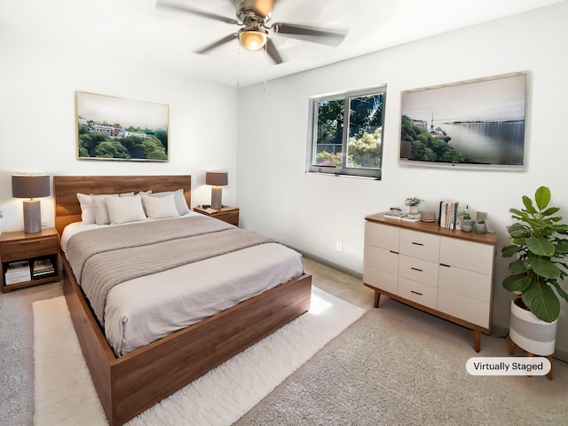 bedroom featuring light colored carpet and ceiling fan