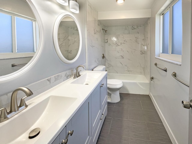 full bathroom featuring double vanity, toilet, baseboards, and a sink