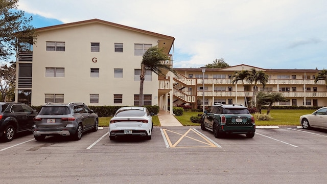 view of property featuring uncovered parking