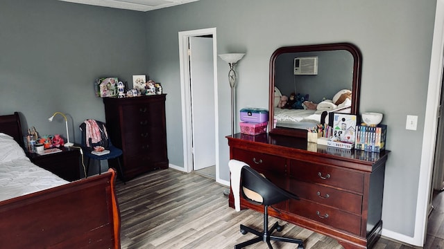 bedroom featuring baseboards and wood finished floors