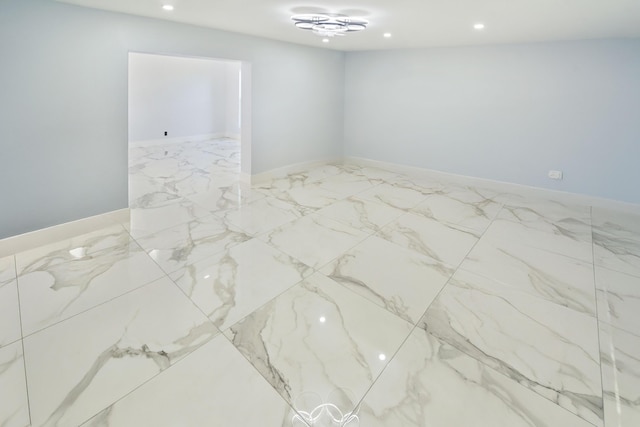 empty room featuring recessed lighting, baseboards, and marble finish floor