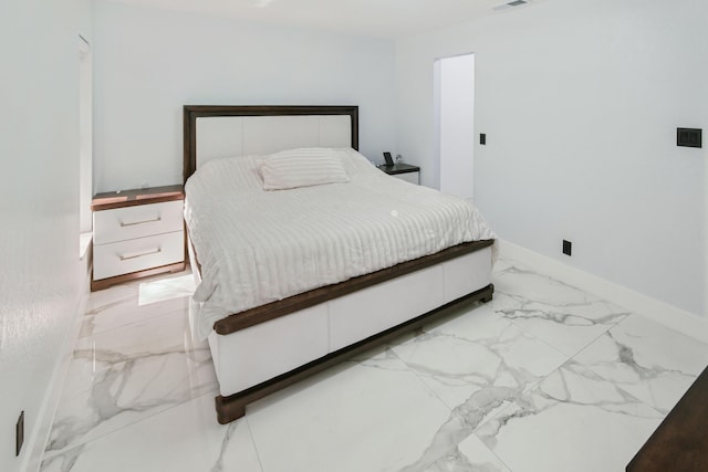 bedroom with visible vents, marble finish floor, and baseboards