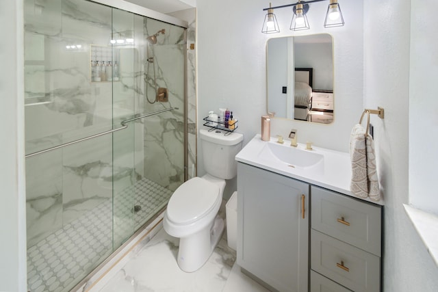 ensuite bathroom with a marble finish shower, toilet, marble finish floor, and ensuite bathroom