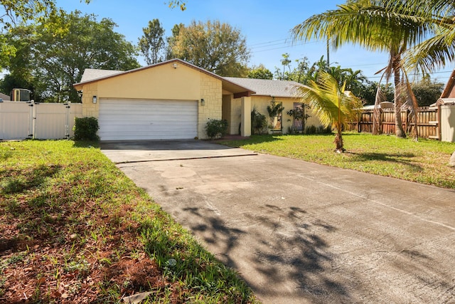 view of front of house with a front yard, a gate, fence, an attached garage, and concrete driveway