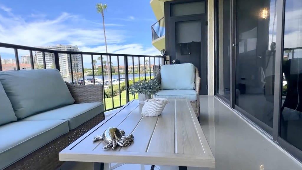 balcony featuring outdoor lounge area and a water view