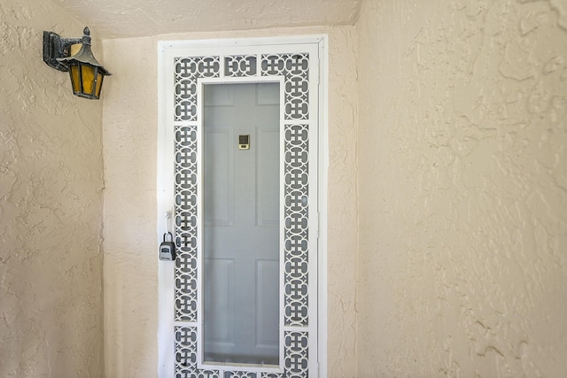 doorway to property with stucco siding