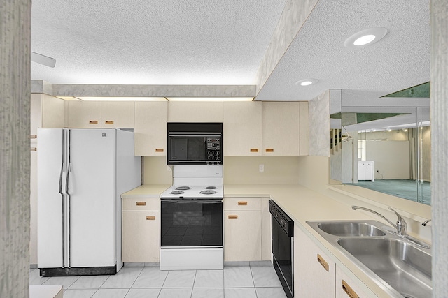 kitchen featuring a sink, a textured ceiling, black appliances, and light countertops