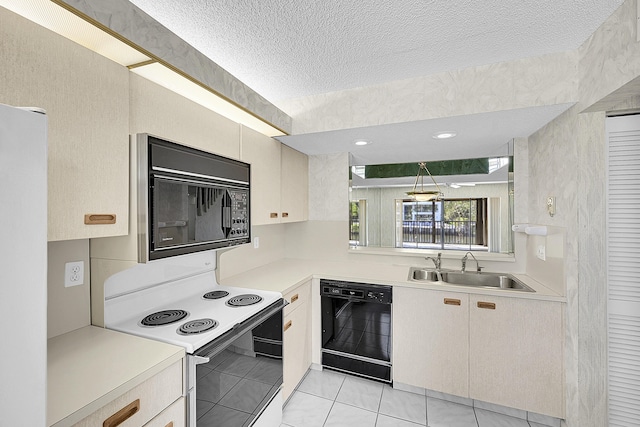 kitchen with a textured ceiling, black appliances, light countertops, and a sink