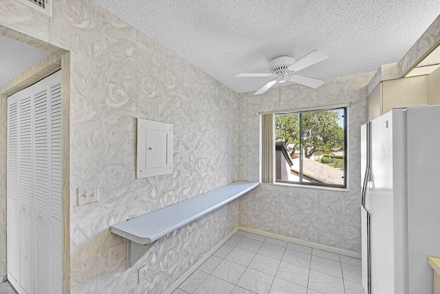 interior space with electric panel, a ceiling fan, and visible vents