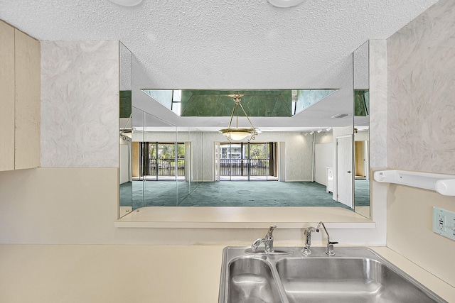 kitchen featuring a sink and a textured ceiling