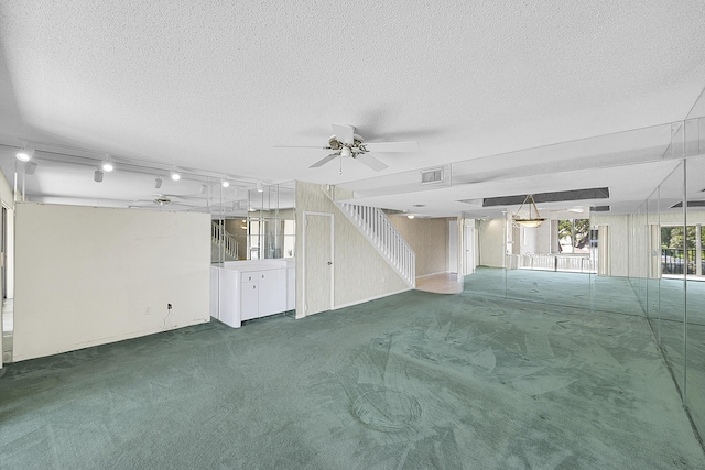 unfurnished living room with visible vents, ceiling fan, stairs, a textured ceiling, and carpet flooring