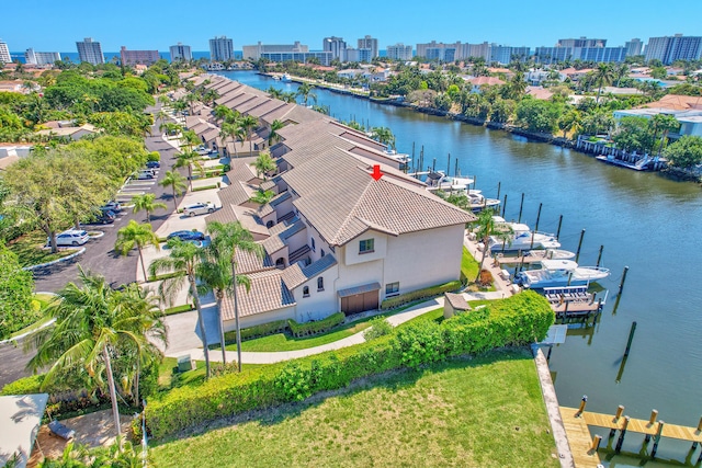 birds eye view of property featuring a view of city and a water view