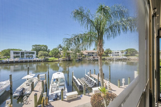 dock area with boat lift and a water view