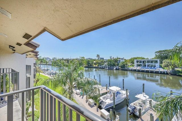 balcony featuring visible vents and a water view