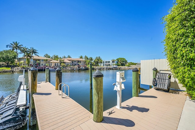 view of dock featuring a water view and a residential view