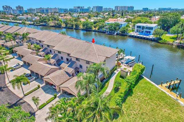 birds eye view of property with a view of city and a water view