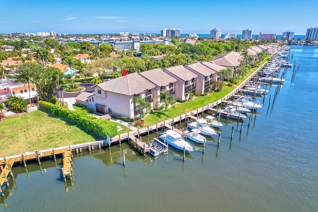 birds eye view of property featuring a city view and a water view