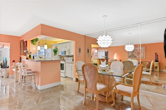 dining area featuring baseboards, a notable chandelier, and marble finish floor