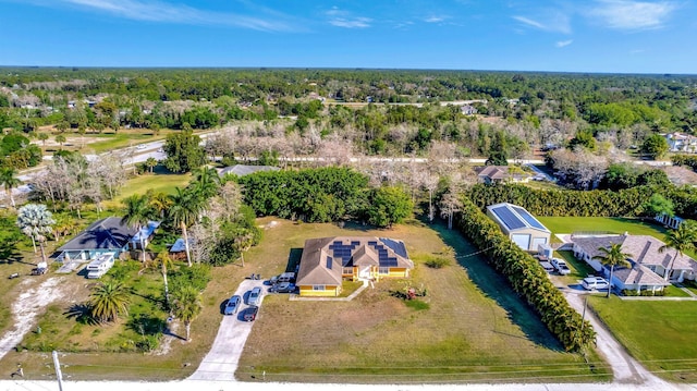 birds eye view of property with a view of trees