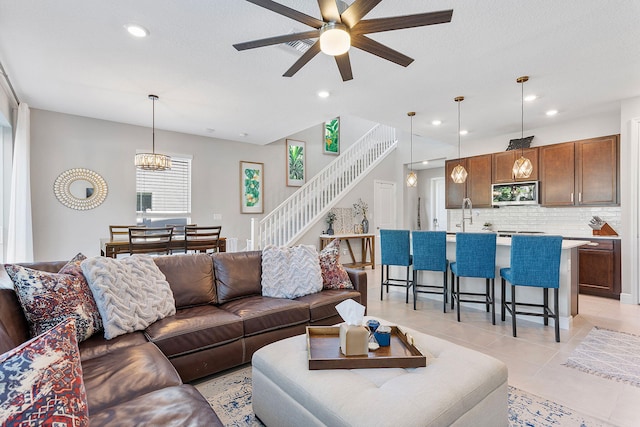 living room featuring recessed lighting, visible vents, light tile patterned flooring, and stairs